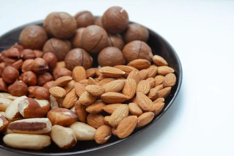 Different types  useful nuts laid out on a plate Stock Photos