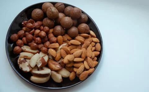Different types  useful nuts laid out on a plate Stock Photos