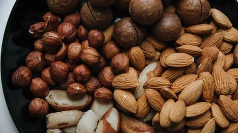 Different types  useful nuts laid out on a plate Stock Photos