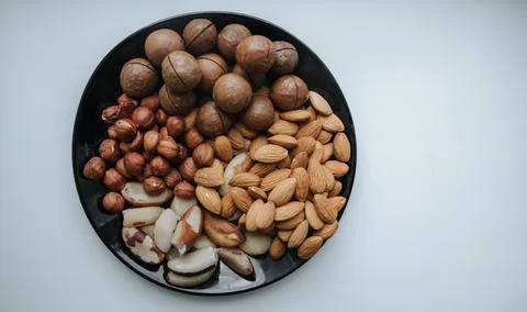Different types  useful nuts laid out on a plate Stock Photos