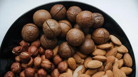 Different types  useful nuts laid out on a plate Stock Photos