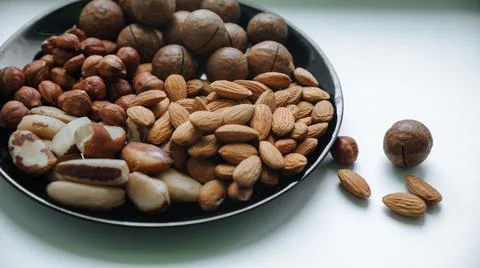 Different types  useful nuts laid out on a plate Stock Photos