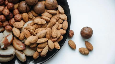 Different types  useful nuts laid out on a plate Stock Photos
