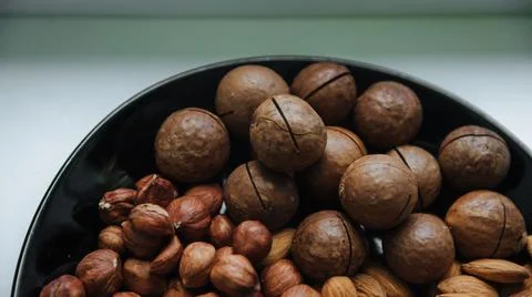Different types  useful nuts laid out on a plate Stock Photos