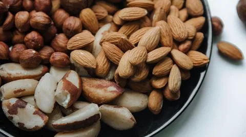 Different types  useful nuts laid out on a plate Stock Photos