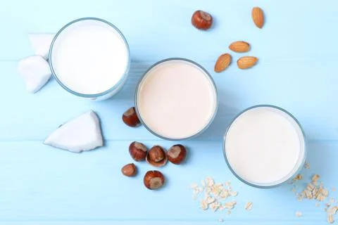 Different types of vegetable milk on the table. Stockfoto's
