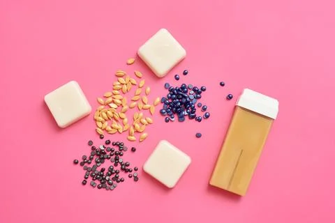 Different types of wax for depilation top view on a pink background Foto stock