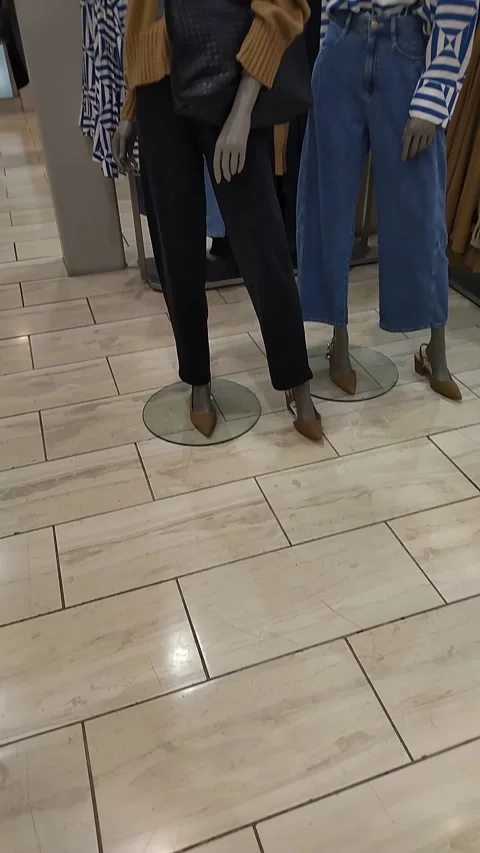 Different types of women's clothes on a hanger in a clothing store Stock Footage 303690714