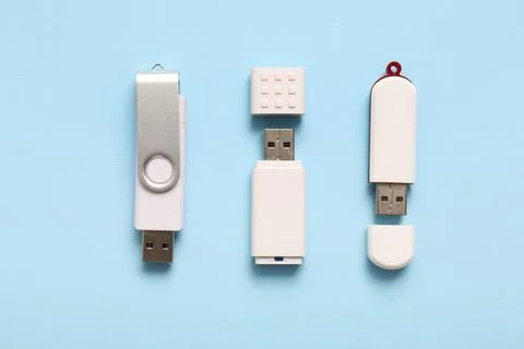 Different USB flash drives on blue background Stock Photos