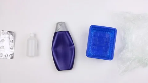 Different used dirty plastic garbage moves on white background, pollution Video stock 113204561