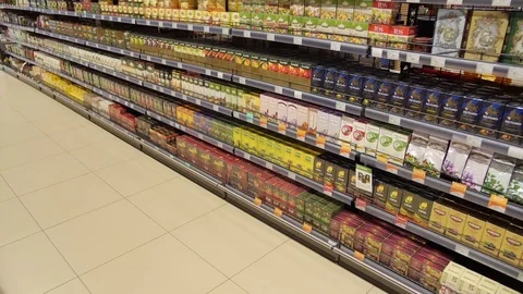 Different varieties and different manufacturers of tea on the shelves in the Stock Footage 75475618
