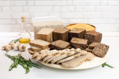 Different varieties of bread on the kitchen table on a light background Stock Photos
