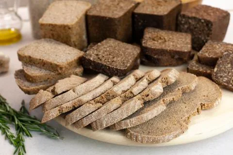 Different varieties of bread on the kitchen table on a light background Stock Photos
