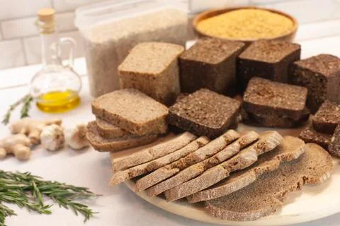 Different varieties of bread on the kitchen table on a light background Stock Photos