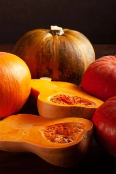 Different varieties of pumpkins on a dark background Stock Photos