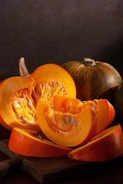 Different varieties of pumpkins on a dark background Stock Photos