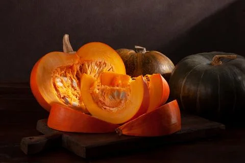 Different varieties of pumpkins on a dark background Stock Photos