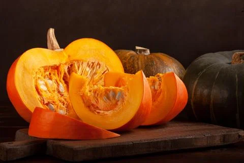 Different varieties of pumpkins on a dark background Stock Photos