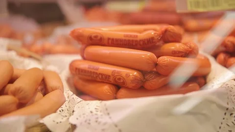 Different varieties of small sausages on the display in the grocery store Stock Footage 75489917