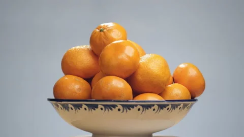 Different varieties of tangerine fruit in a vase. Rotation Stock Footage 124533387