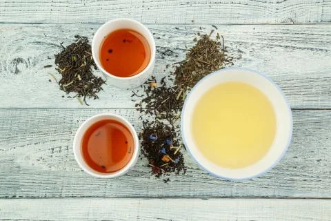Different varieties of tea on the table and in tea glasses on a white shabby  Stock Photos