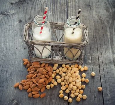 Different vegan milks on a table Stock Photos