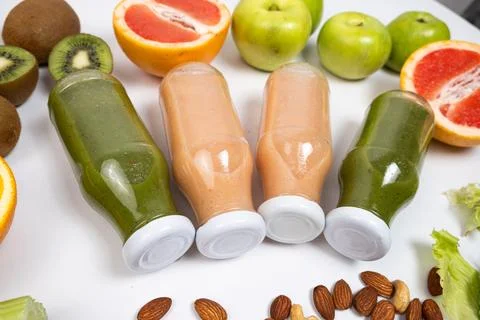 Different vegetable and fruit smoothies in glass bottles on white background Stock Photos