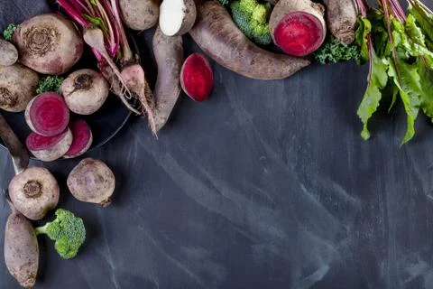 Different vegetables on black with plate Stock Photos