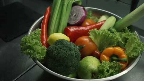 Different vegetables in the bowl on table. Fresh organic lettuce leaves, onion Stock Footage 85169938