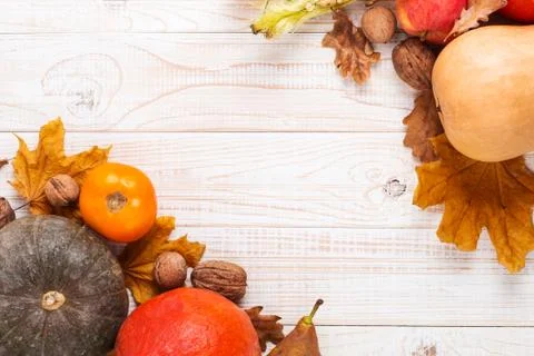 Different vegetables, pumpkins, apples, pears, nuts, tomatoes and dry leaves  Stock Photos