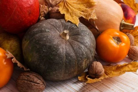 Different vegetables, pumpkins, apples, pears, nuts, tomatoes and dry leaves  Stock Photos
