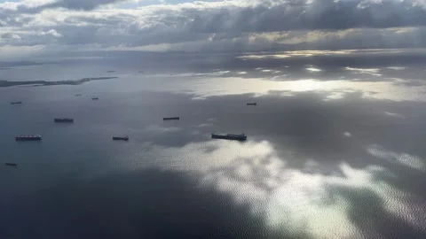 Different vessels drift in ocean bay reflecting cloudy sky Stock Footage 145572530