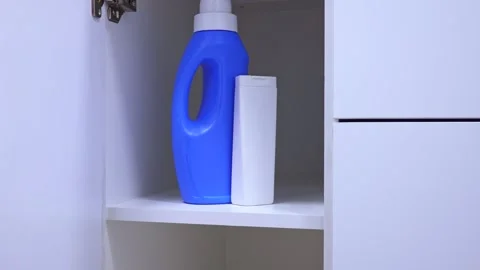 Different washing detergent bottles on the shelf in bathroom Stock Footage 265248878