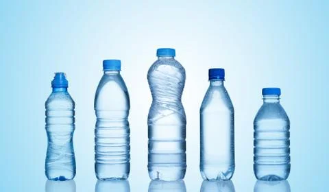 Different water bottles on blue background Stock Photos