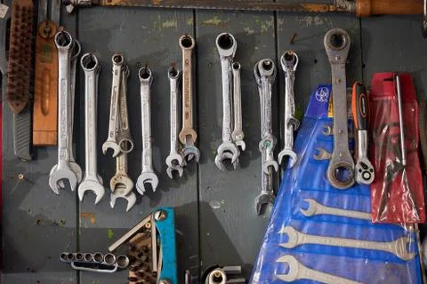 Different wrenches hanging on wall Stock Photos