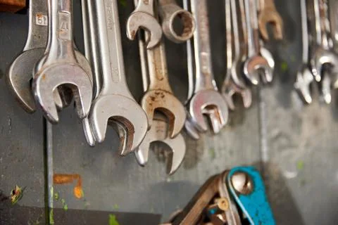 Different wrenches hanging on wall Stock Photos
