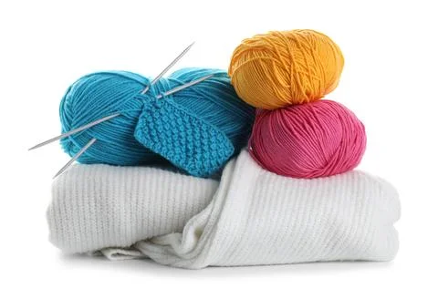 Different yarns, knitting needles, pattern sample and sweaters isolated on .. Stock Photos