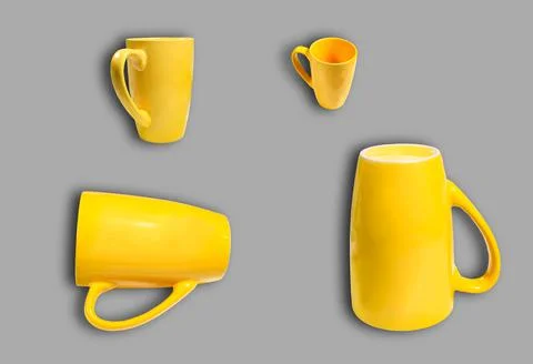 Different yellow cups on a gray background. Foto stock