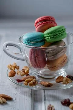 Differnt color macaroons in a tea cup Stock Photos