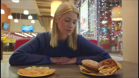 Difficult Choice between Fast Food and Vegetables Stock Footage 60368630