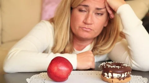 Difficult choice between healthy or junk food, diet concept 4 Stock-Footage 70322293