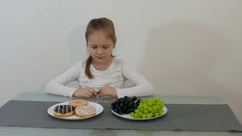 Difficult Choice Between Healthy Or Junk Food Stock Footage 73267661