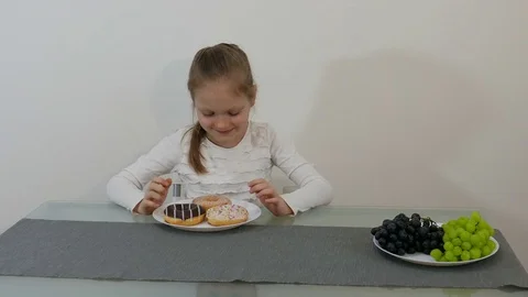 Difficult Choice Between Healthy Or Junk Food Stock Footage 76871662