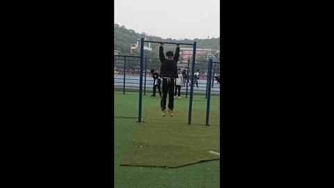 Difficult pull-ups performed by a teenager in Guang'an, China Stock Footage 277524376