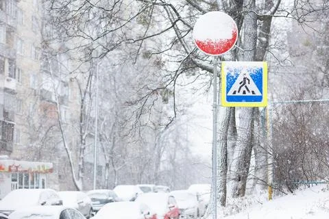 Difficult road conditions - road in the winter snowfall with pedestrian cross Stock Photos