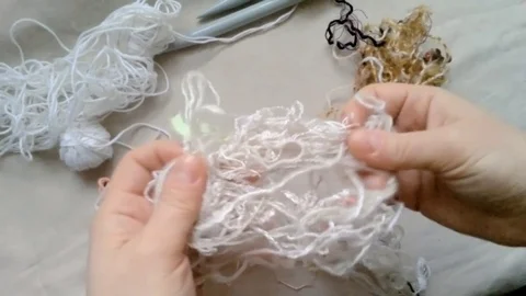 Difficult task of unraveling threads for knitting Stock Footage 72915789