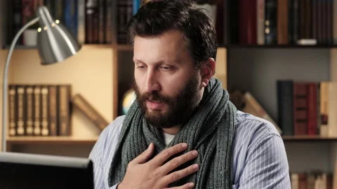 Difficulty breathing, chest pain. Man in scarf at workplace in office or Stock Footage 139284139