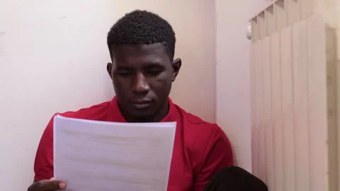 Difficulty, discouragement-young black man discouraged by bureaucratic paperwork Stock Footage 240322352