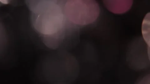 Diffuse, low-luminosity lights superimposed on each other in multi-colored black Stock Footage 318675313