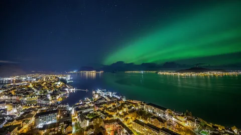 Diffuse Northern Lights above city of Alesund Stock Footage 250465306